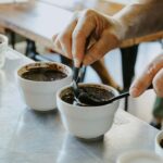 person mixing black coffee